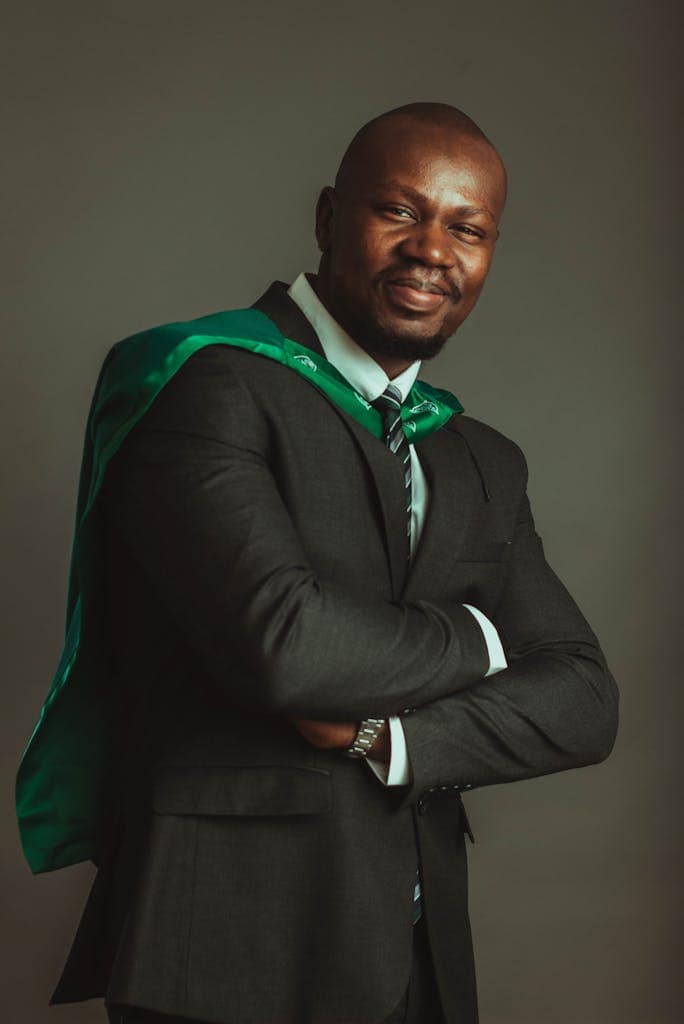 Portrait of a confident businessman with a green cape, symbolizing leadership and strength.
