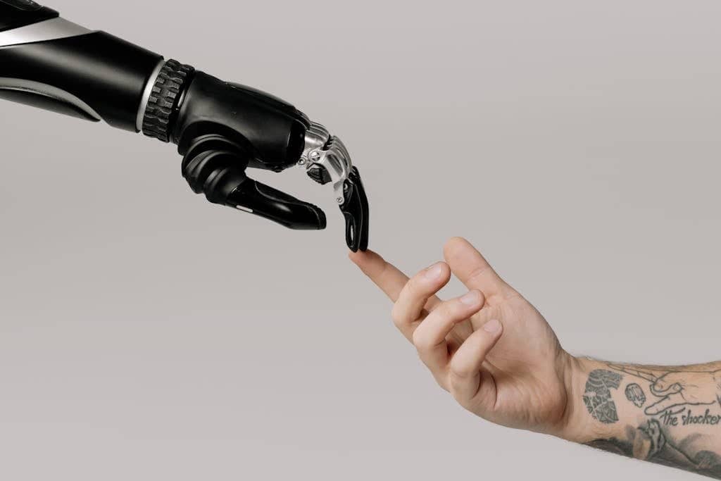 A human hand with tattoos reaching out to a robotic hand on a white background. AI sevices by rocket host